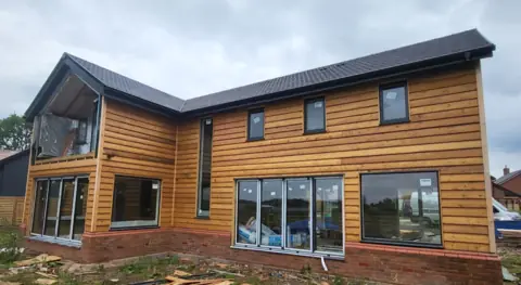 A timber-clad exterior during the project — CG Cladding Solutions