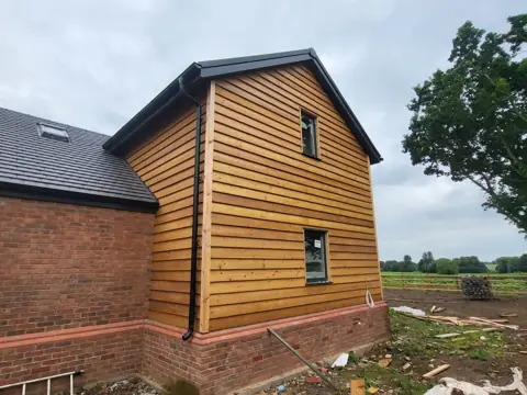 Timber-clad gable during the project — CG Cladding Solutions